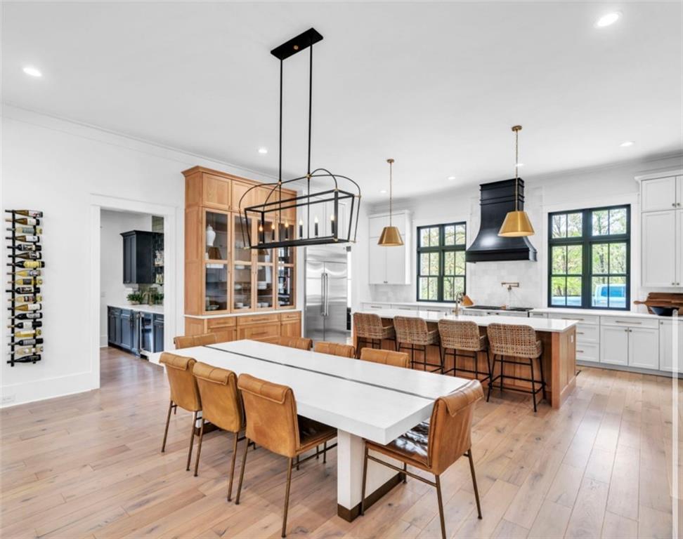 1560 Howell Bridge Road Ball Ground, GA 30107 - Photo 9 of 14 a view of a dining room and livingroom with furniture wooden floor a chandelier