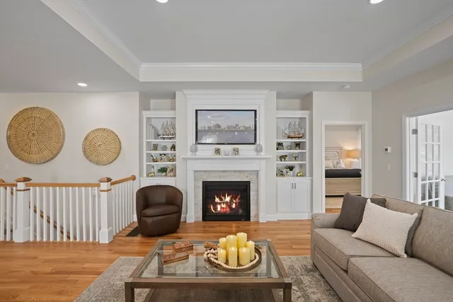 a living room with furniture a fireplace and a large window