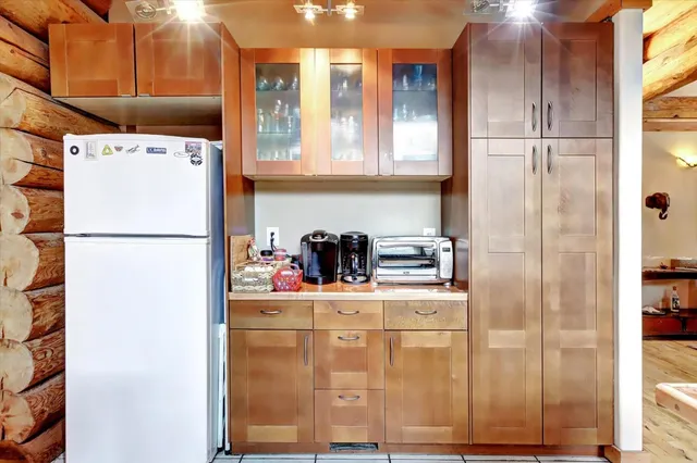 a view of a dining room with furniture and a book shelf