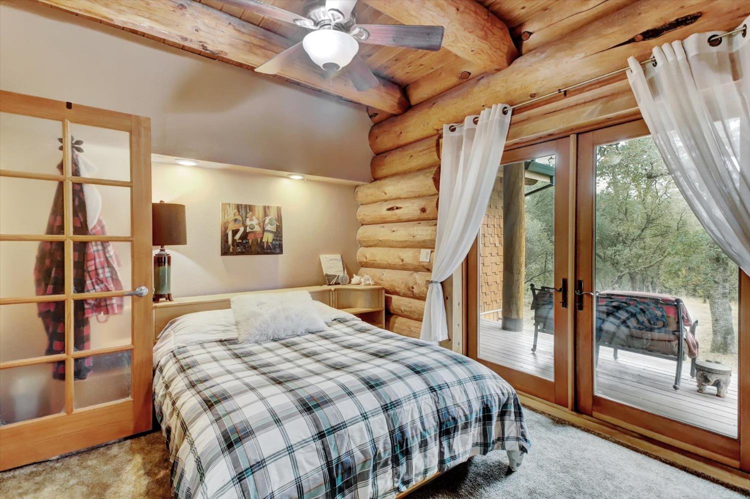 9844 Township Road Browns Valley, CA 95918 - Photo 16 of 35 a bedroom with a large bed and a chandelier