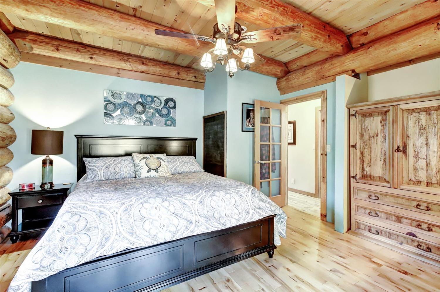 9844 Township Road Browns Valley, CA 95918 - Photo 17 of 35 a bedroom with a large bed and a chandelier