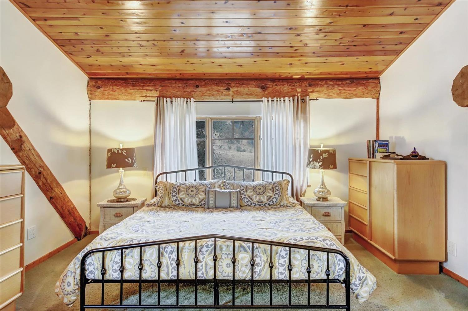 9844 Township Road Browns Valley, CA 95918 - Photo 20 of 35 a bedroom with a bed a mirror and dresser