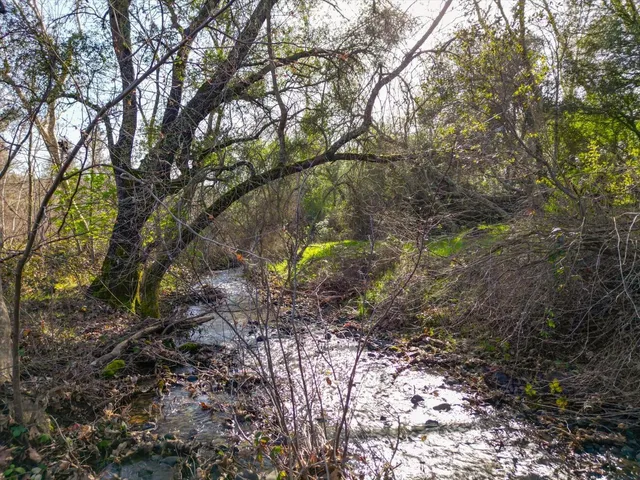 a backyard of a house with a yard and outdoor seating