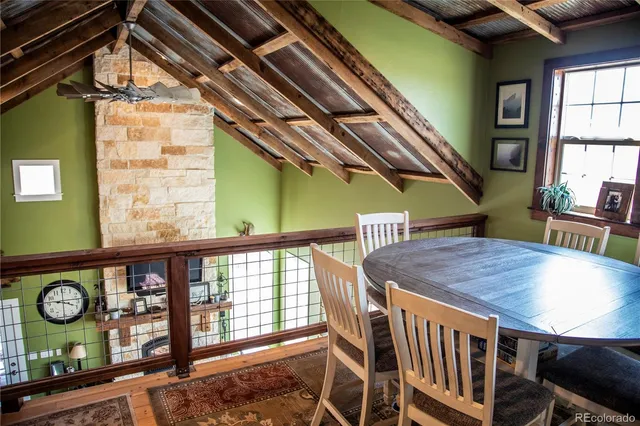 a view of a chairs and table in the balcony
