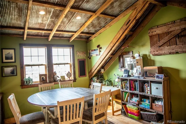 a dining room with furniture and a book shelf