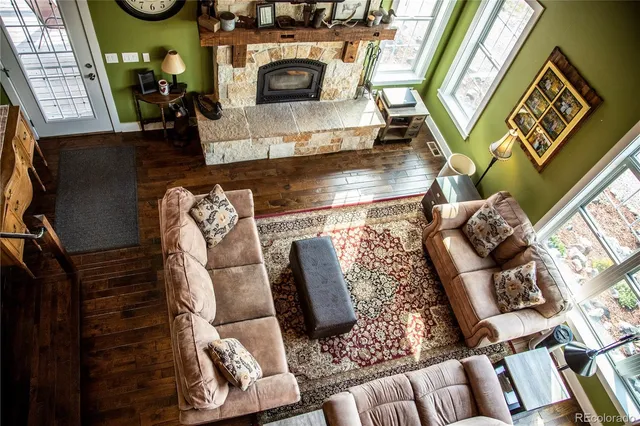 a view of living room with furniture and a fireplace