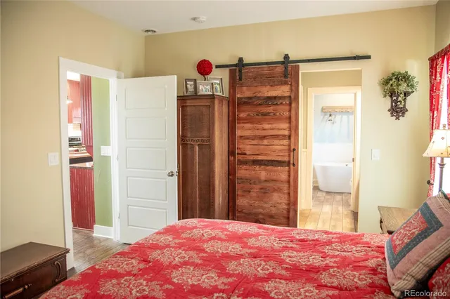 a bathroom with a granite countertop toilet sink and mirror