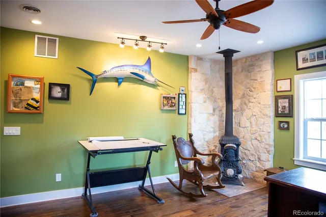 a view of a room with wooden floor and a window
