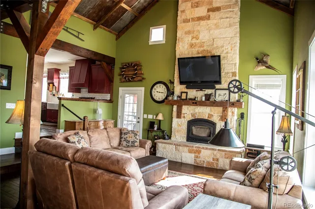 a living room with furniture a flat screen tv and a fireplace