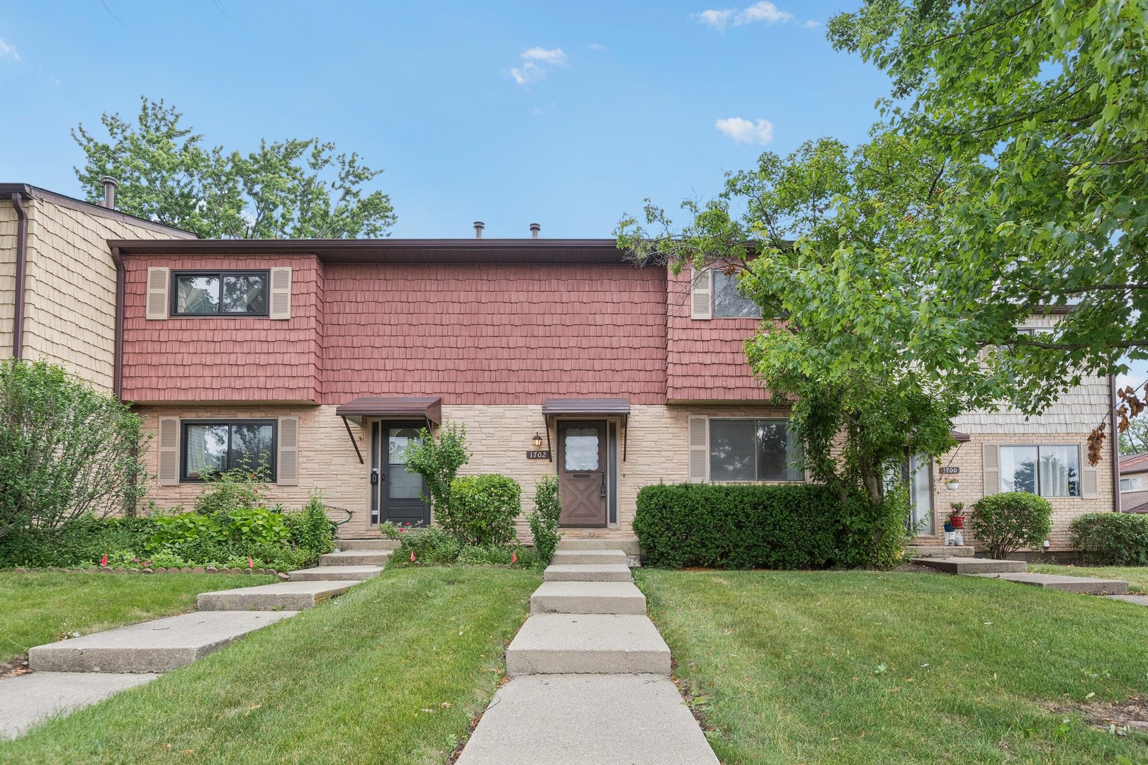 a front view of a house with a garden