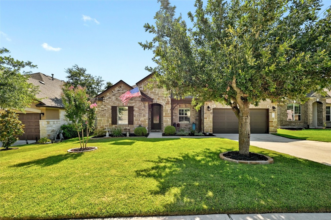 4933 Pyrenees Pass Bee Cave, TX 78738 - Photo 1 of 1 a front view of a house with a yard and trees