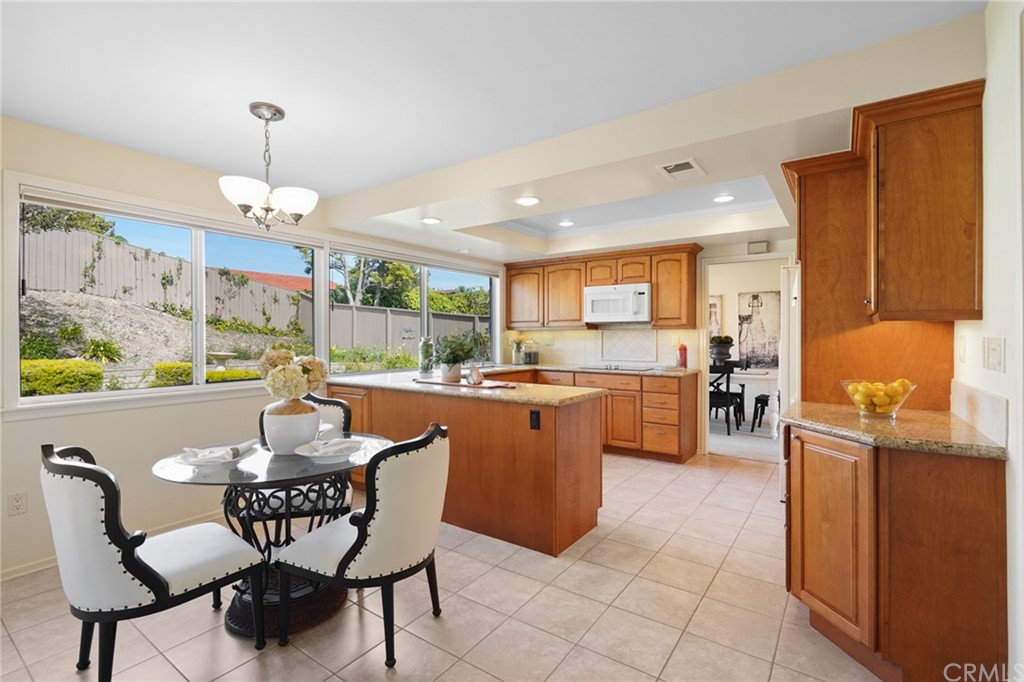 26623 Nokomis Road Rancho Palos Verdes, CA 90275 - Photo 11 of 42 a kitchen with a dining table chairs and large window