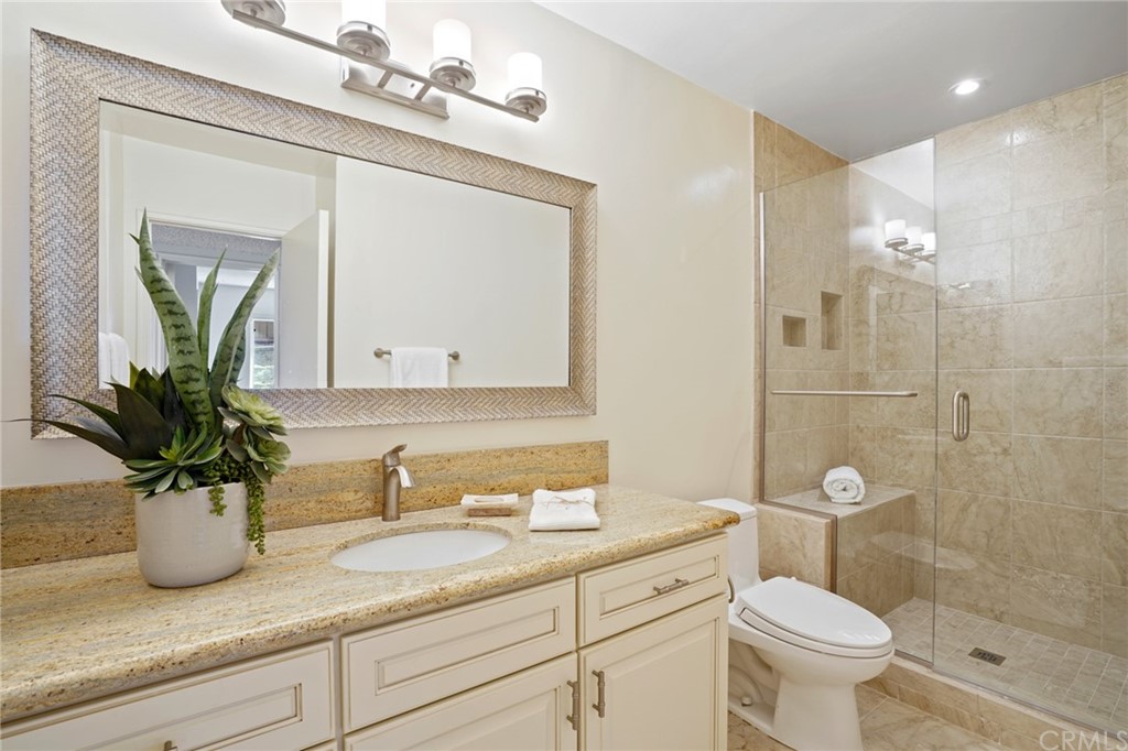 26623 Nokomis Road Rancho Palos Verdes, CA 90275 - Photo 22 of 42 a bathroom with a granite countertop sink a toilet and shower