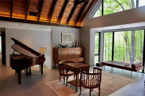 a kitchen with kitchen island granite countertop a stove a refrigerator a sink a dining table and chairs with wooden floor