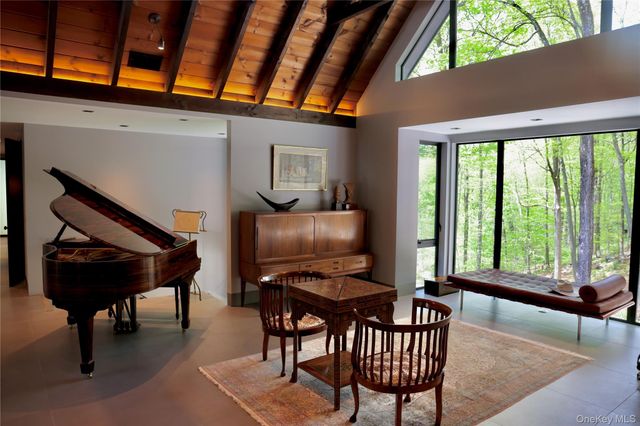 a kitchen with kitchen island granite countertop a stove a refrigerator a sink a dining table and chairs with wooden floor