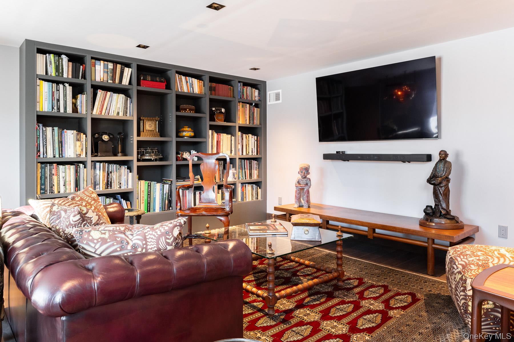 49 Indian Hill Road Pound Ridge, NY 10576 - Photo 20 of 34 a living room with furniture and a flat screen tv