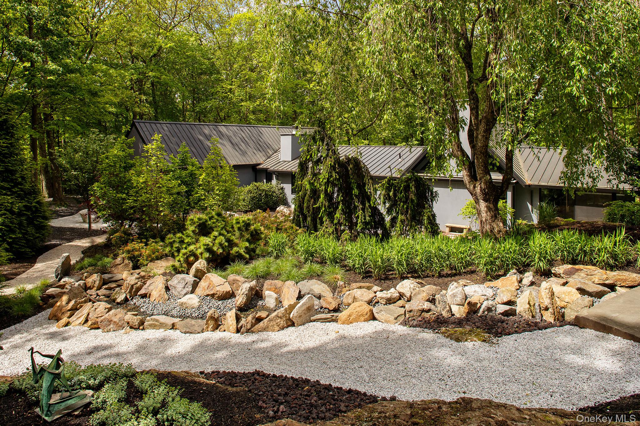 49 Indian Hill Road Pound Ridge, NY 10576 - Photo 29 of 34 View of front of house featuring a standing seam roof, metal roof, and stucco siding