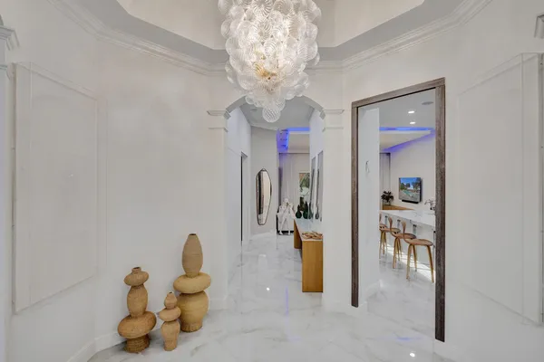 a dining room with furniture and a chandelier