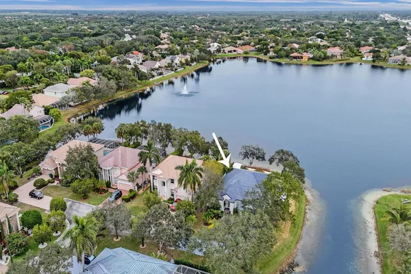 an aerial view of a house with a lake view