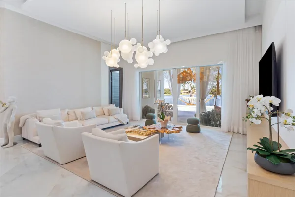 a living room with fireplace furniture and a chandelier