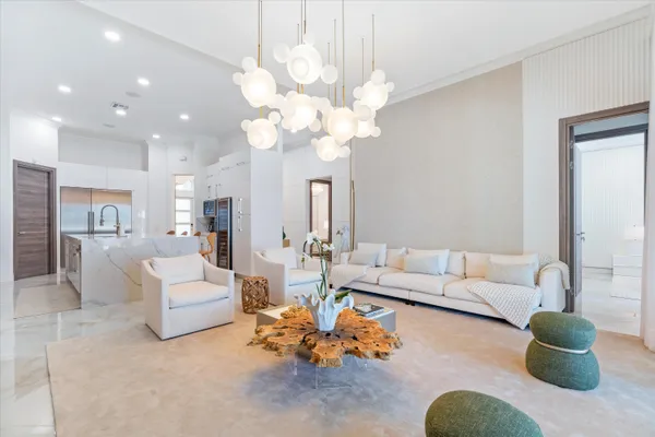 a living room with furniture potted plant and a chandelier