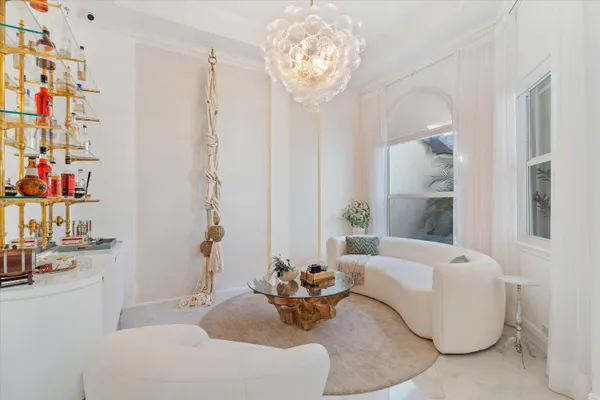 a living room with furniture and a chandelier