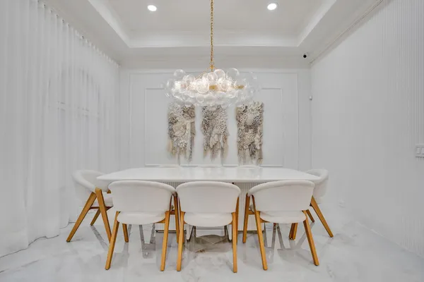a view of a dining room with furniture and chandelier