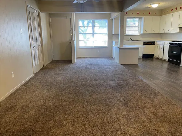 a view of a kitchen next to a window