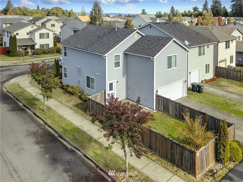 3075 Walker Road DuPont, WA 98327 - Photo 23 of 27 a view of a house with wooden fence