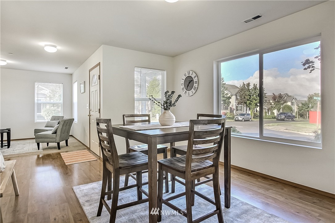 3075 Walker Road DuPont, WA 98327 - Photo 4 of 27 a view of a dining room with furniture window and wooden floor