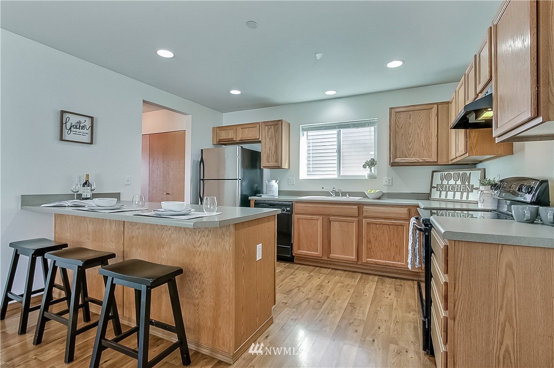 3075 Walker Road DuPont, WA 98327 - Photo 8 of 27 a kitchen with granite countertop a sink and cabinets
