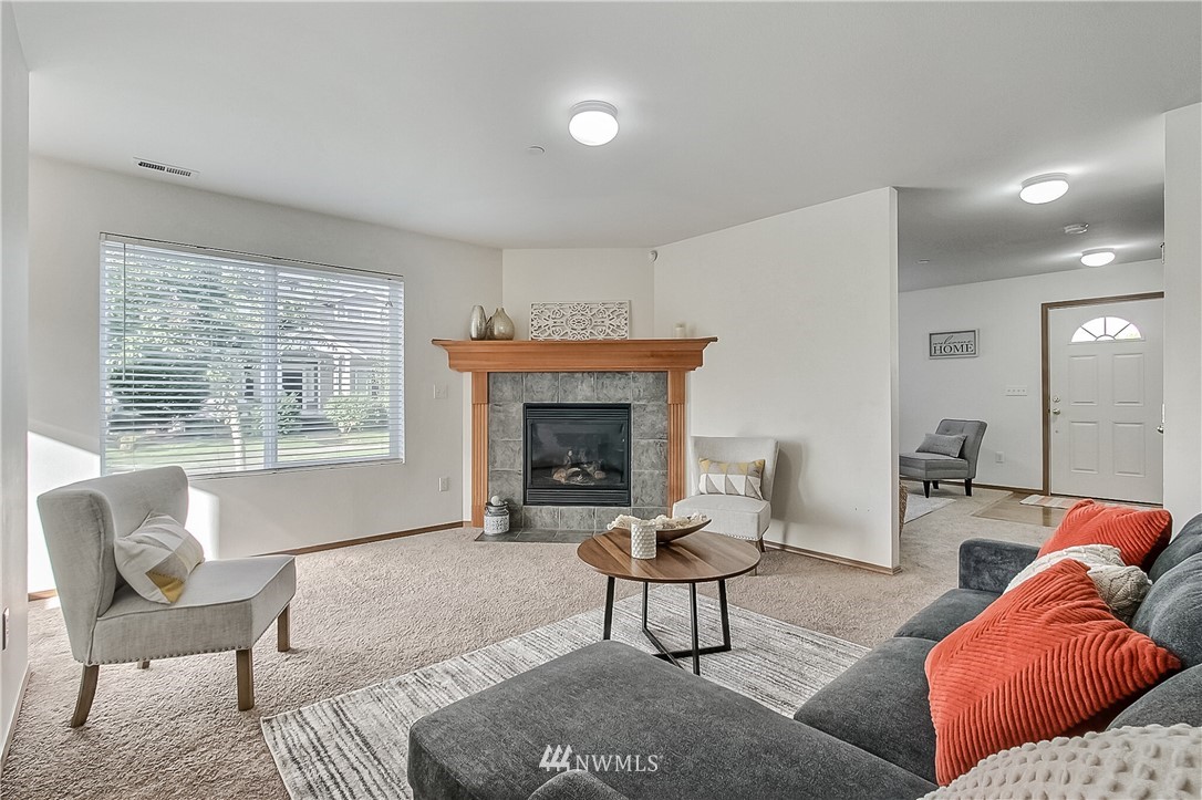 3075 Walker Road DuPont, WA 98327 - Photo 9 of 27 a living room with furniture and a fireplace