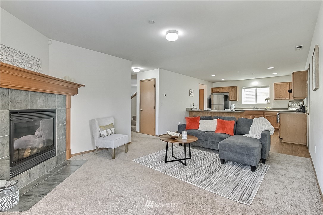 3075 Walker Road DuPont, WA 98327 - Photo 10 of 27 a living room with furniture and a fireplace
