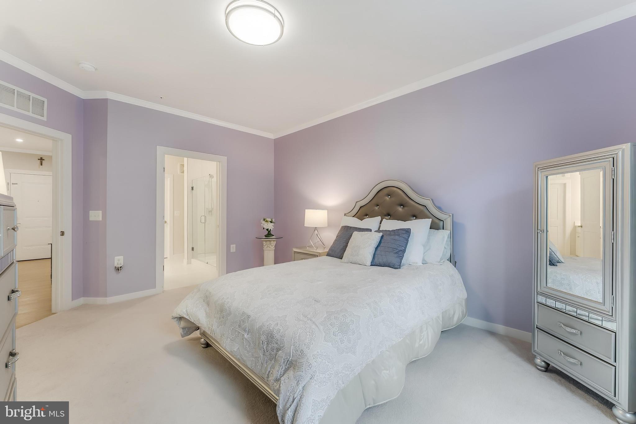 1675 Bandit Loop, Unit 105B Reston, VA 20190 - Photo 20 of 27 a bedroom with a bed and a lamp