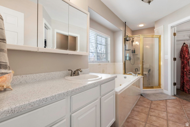 13176 Day Court Draper, UT 84020 - Photo 15 of 45 Bathroom featuring a shower stall, a walk in closet, vanity, a garden tub, and light tile patterned flooring