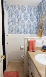 a bathroom with a granite countertop sink and a window