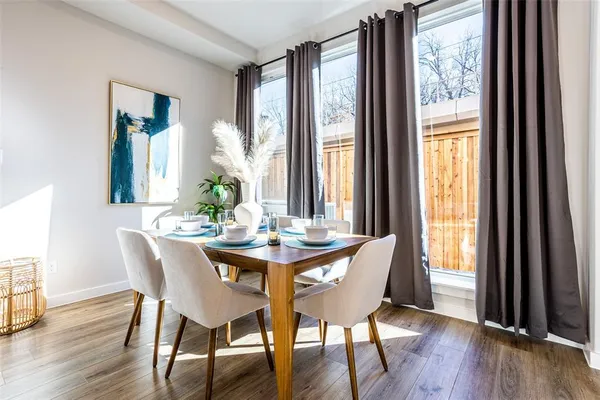 a view of a dining room with furniture and wooden floor