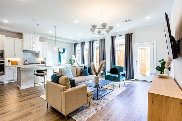 a living room with furniture wooden floor and a flat screen tv