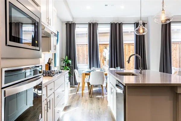 a kitchen with stainless steel appliances a sink stove and cabinets