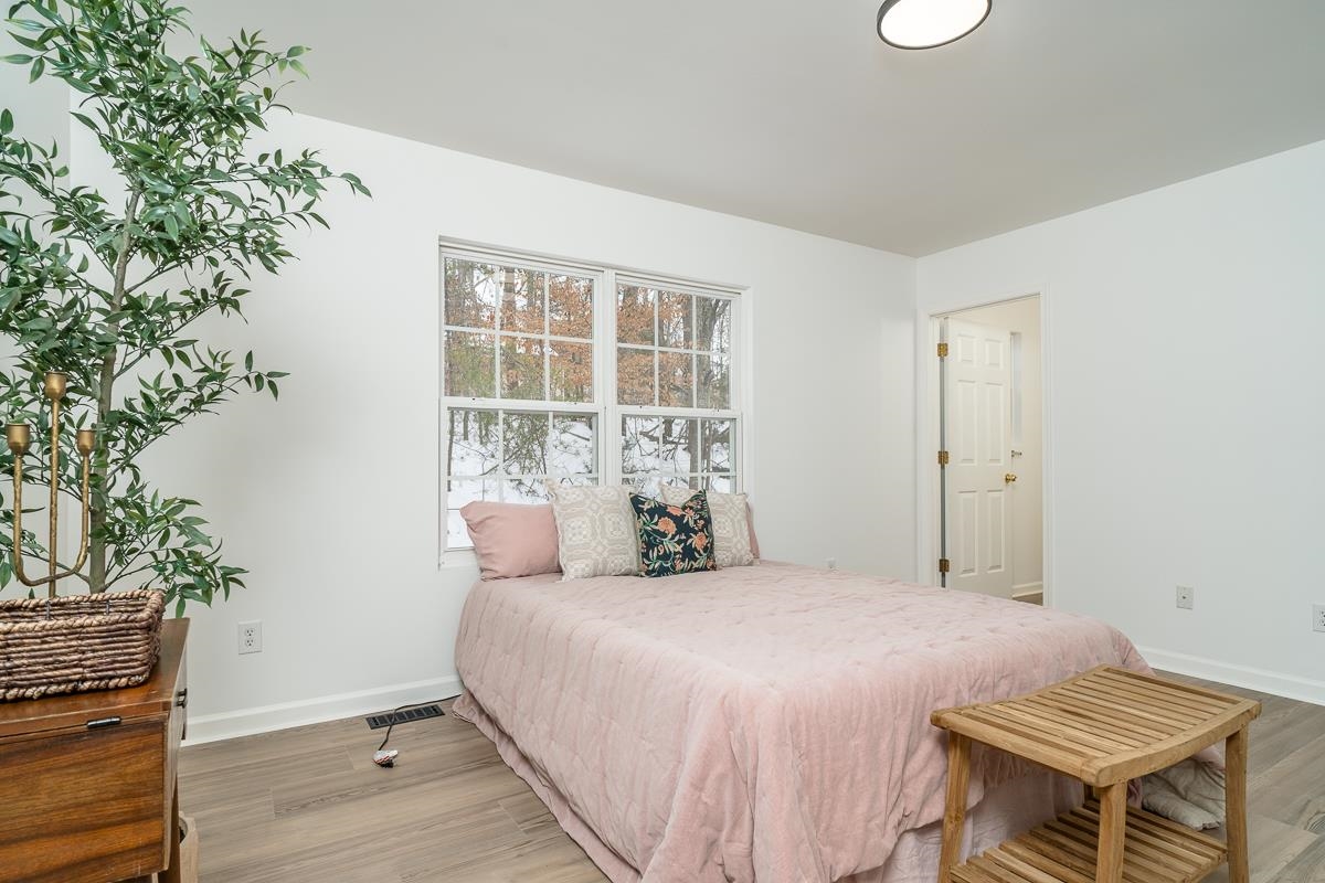 37 Hatchechubee Road Palmyra, VA 22963 - Photo 11 of 27 a bedroom with a bed and a potted plant