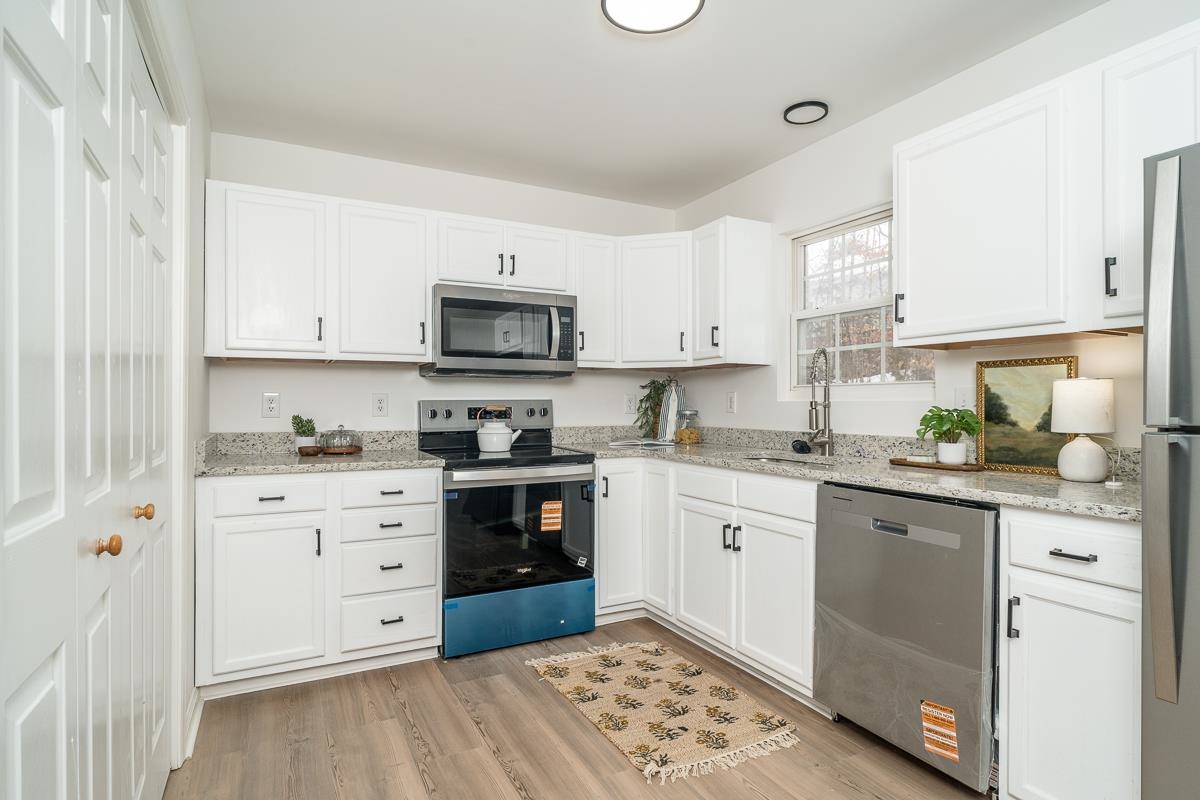 37 Hatchechubee Road Palmyra, VA 22963 - Photo 2 of 27 a kitchen with granite countertop white cabinets and white appliances