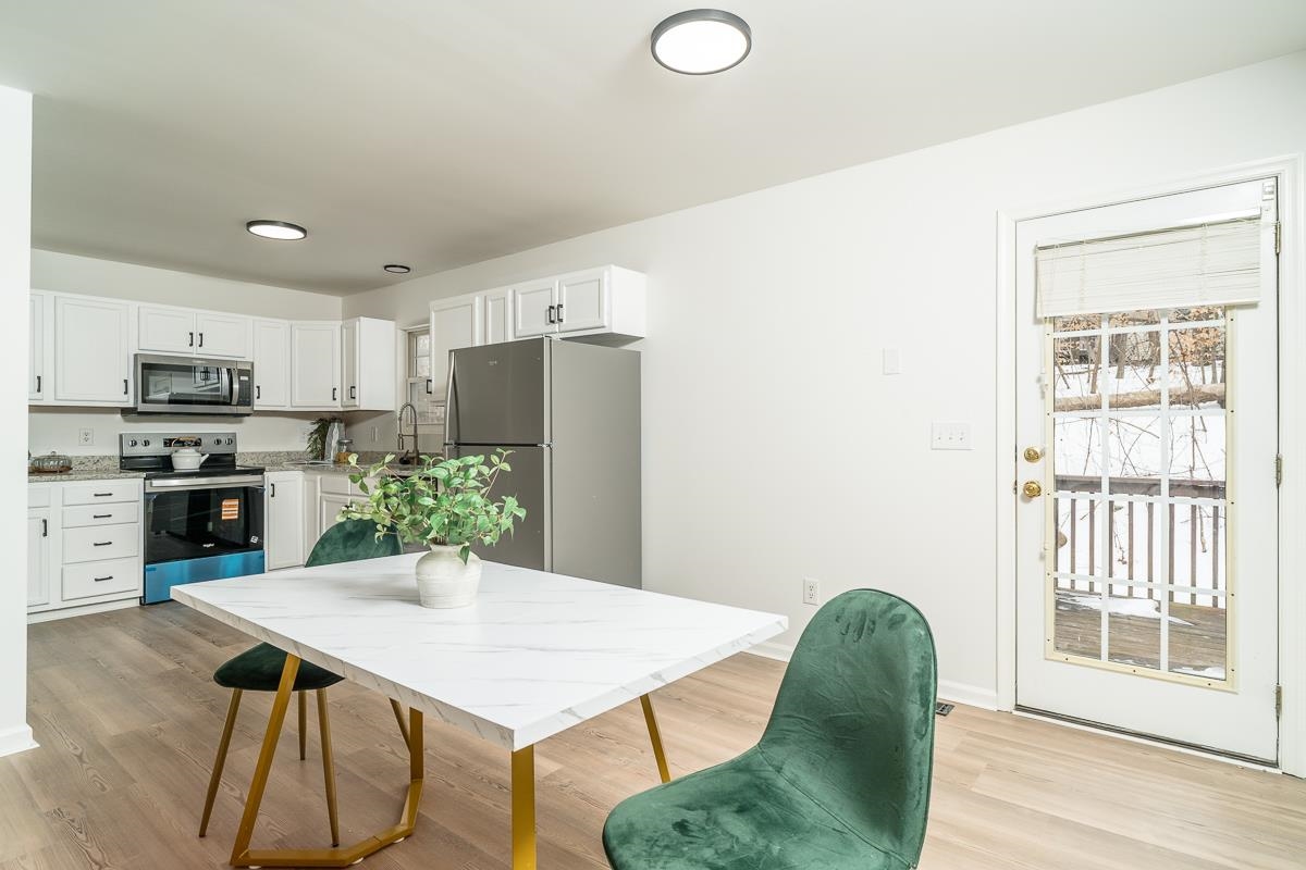 37 Hatchechubee Road Palmyra, VA 22963 - Photo 4 of 27 a kitchen with stainless steel appliances granite countertop a refrigerator a stove top oven a sink dishwasher and white cabinets with wooden floor
