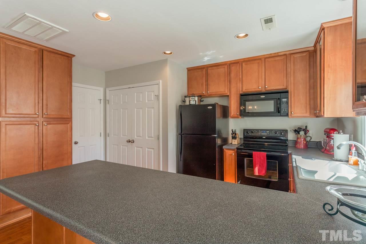 2120 Piney Brook Road, Unit 102 Raleigh, NC 27614 - Photo 12 of 24 a kitchen with stainless steel appliances granite countertop a refrigerator stove and sink