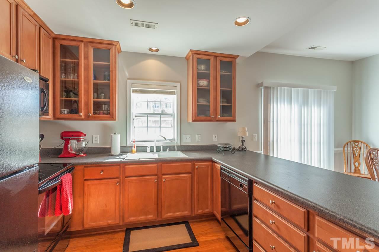 2120 Piney Brook Road, Unit 102 Raleigh, NC 27614 - Photo 13 of 24 a kitchen with a sink stove and cabinets