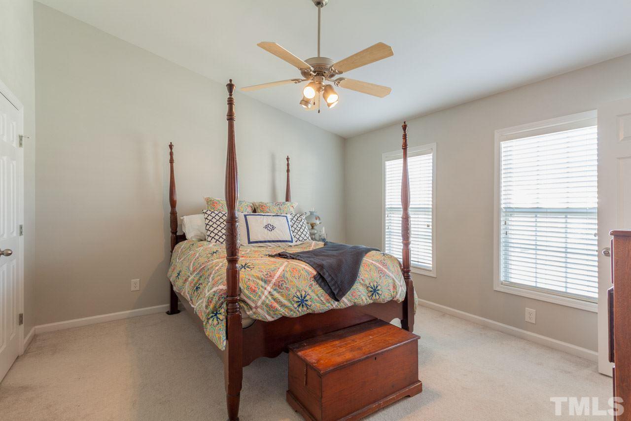 2120 Piney Brook Road, Unit 102 Raleigh, NC 27614 - Photo 15 of 24 a bed room with a bed and a ceiling fan