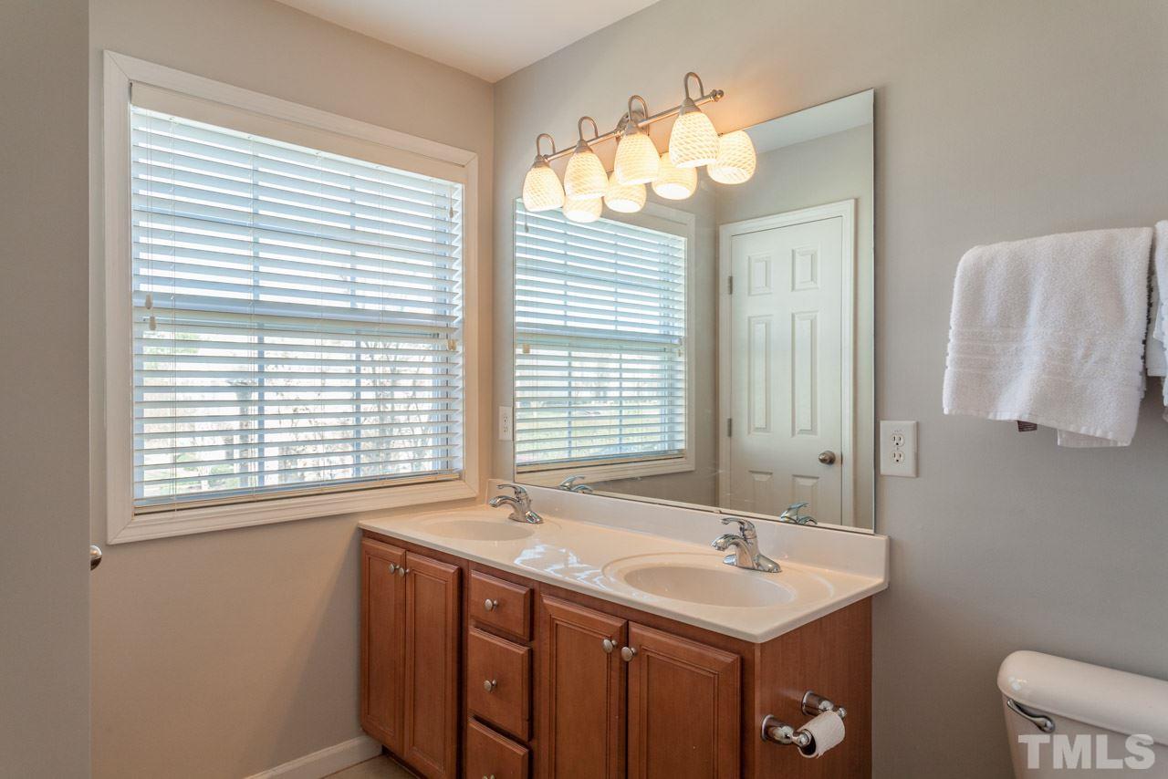 2120 Piney Brook Road, Unit 102 Raleigh, NC 27614 - Photo 17 of 24 a bathroom with a sink and a mirror