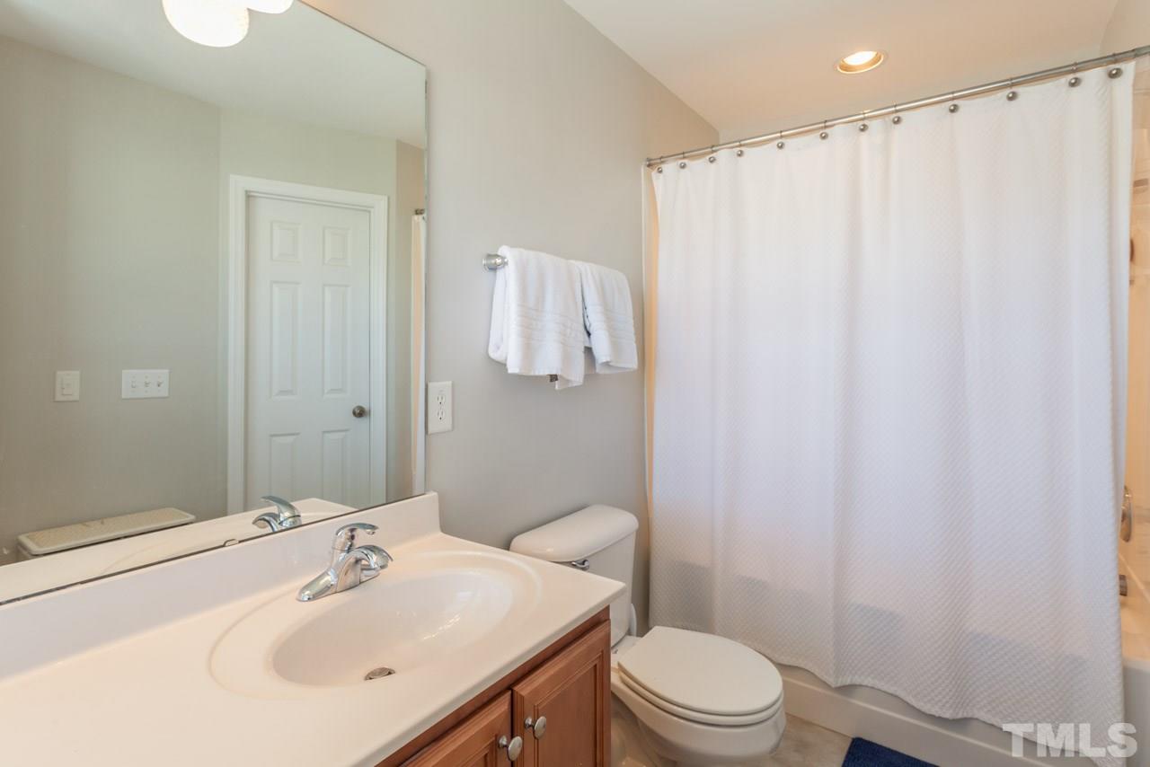2120 Piney Brook Road, Unit 102 Raleigh, NC 27614 - Photo 18 of 24 a bathroom with a sink a toilet and shower