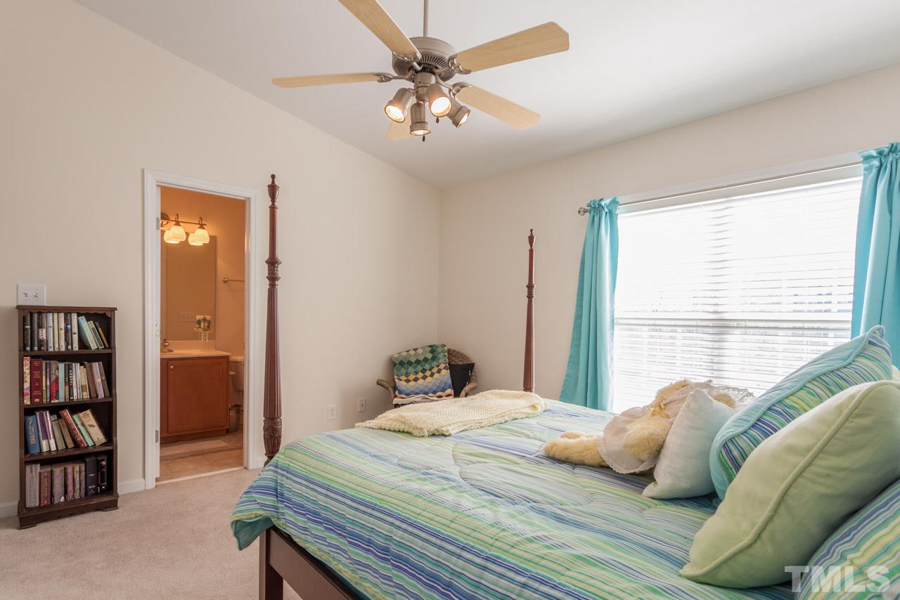 2120 Piney Brook Road, Unit 102 Raleigh, NC 27614 - Photo 20 of 24 a bedroom with a bed cabinets and window