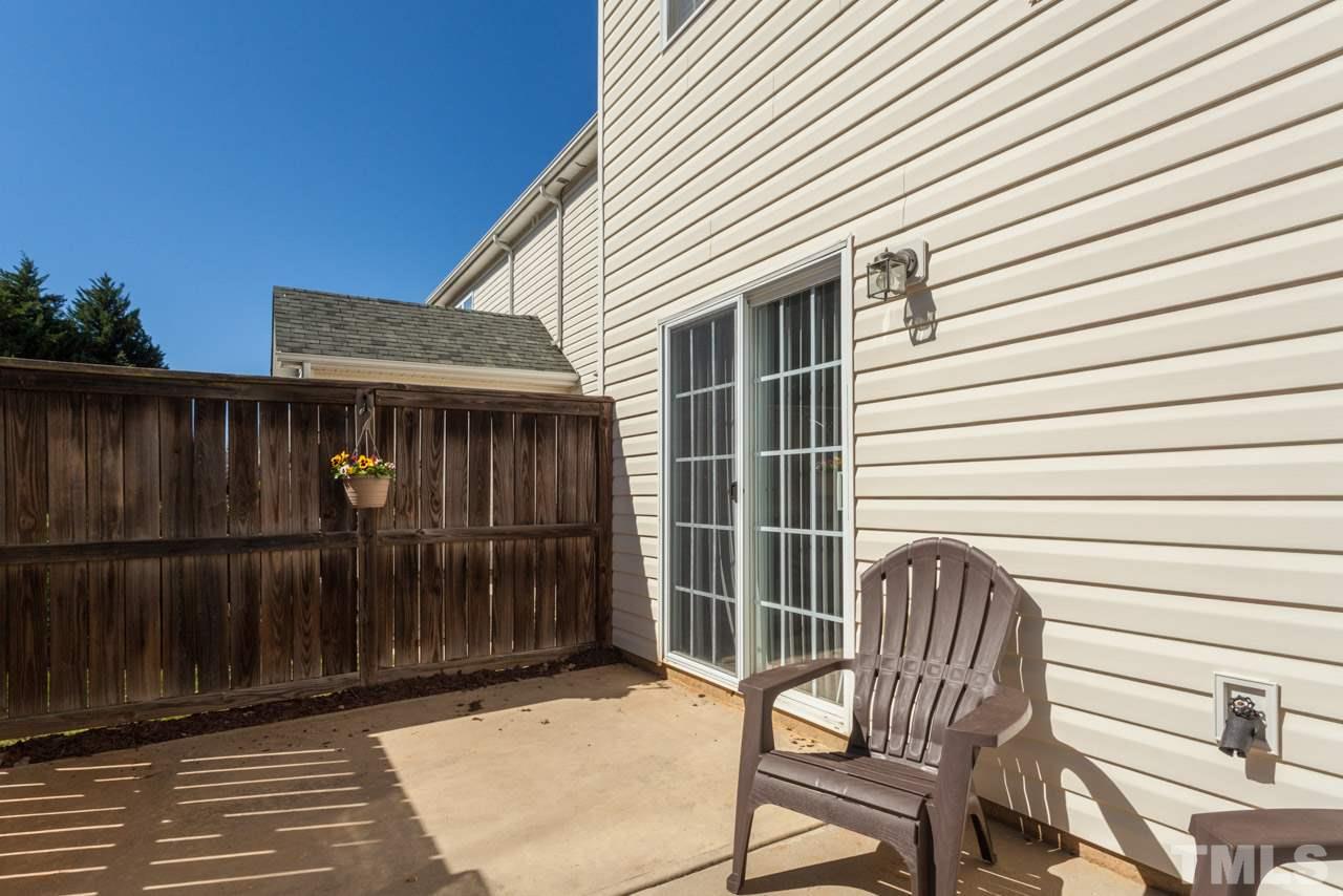 2120 Piney Brook Road, Unit 102 Raleigh, NC 27614 - Photo 22 of 24 a view of a chair and table in the back yard of the house