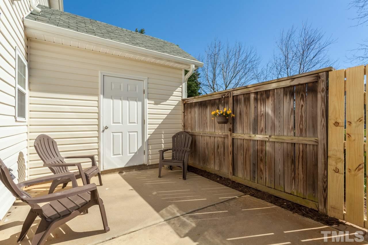 2120 Piney Brook Road, Unit 102 Raleigh, NC 27614 - Photo 23 of 24 a backyard of a house with table and chairs